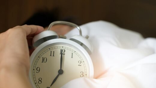 photo of person holding alarm clock