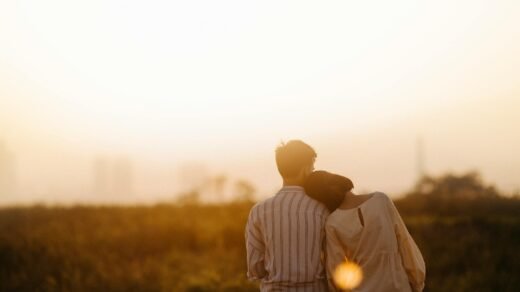 man and woman near grass field