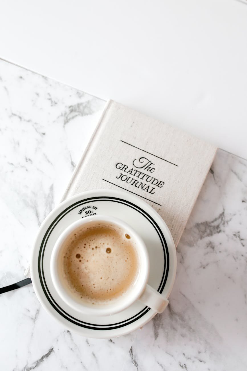 cozy coffee and gratitude journal on marble