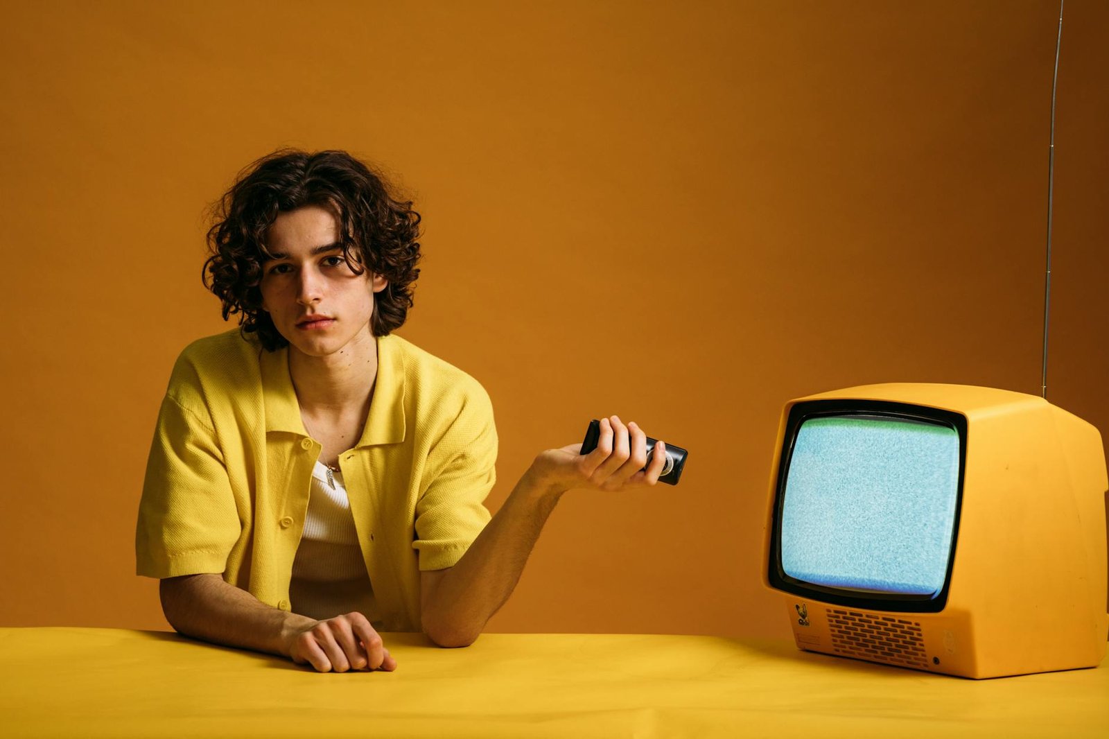 young man holding a remote control