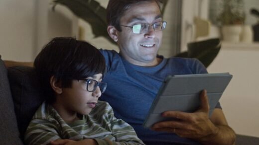 father and son watching video